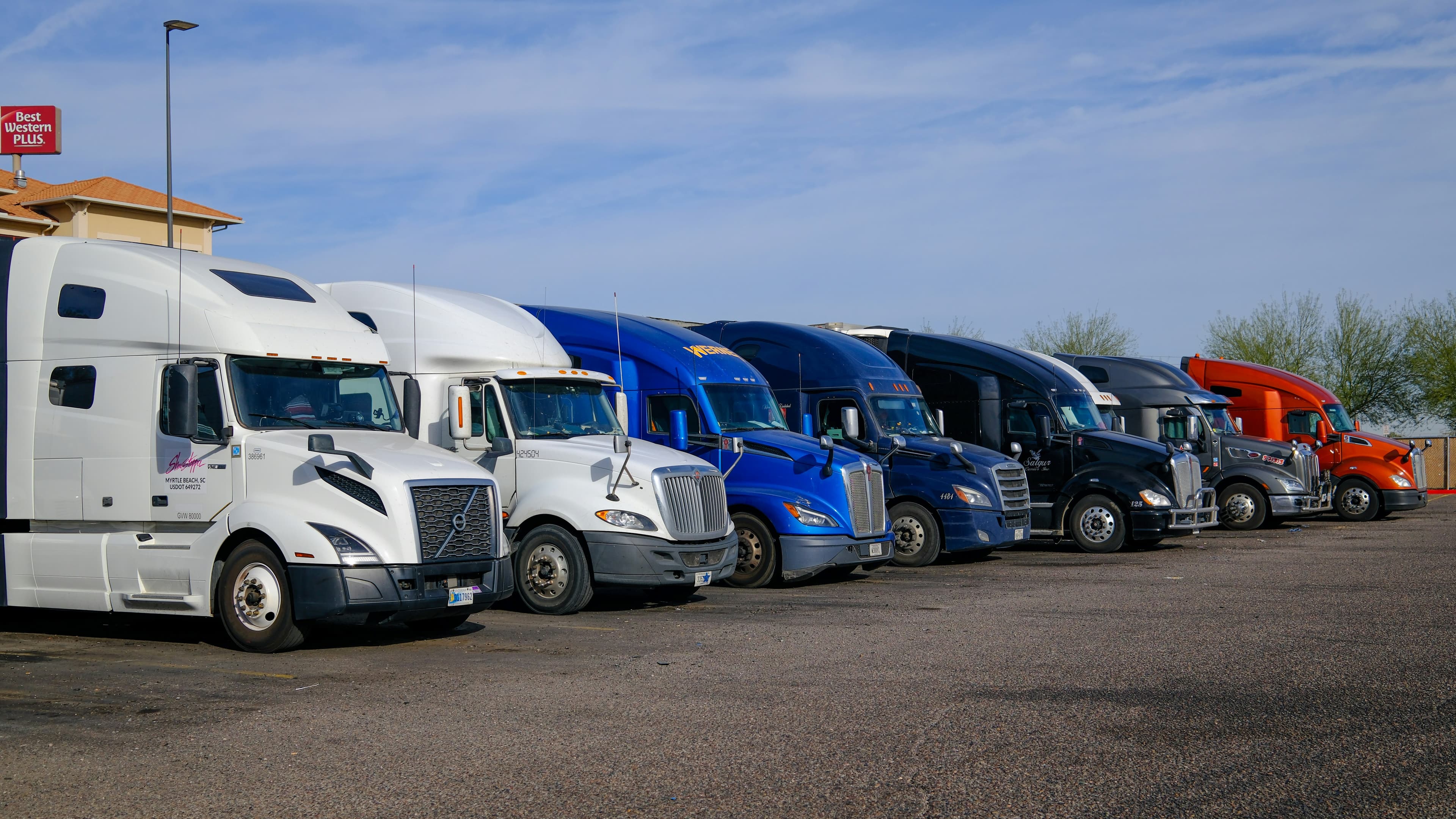 Multiple semi trucks lined up at commercial fleet lot for on-site CARB truck checks
